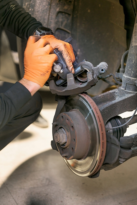 Car mechanic repair brake pads close up. Car Mechanic Repair Brake Pads Close Up., by Zoonar DAVID HERRAEZ