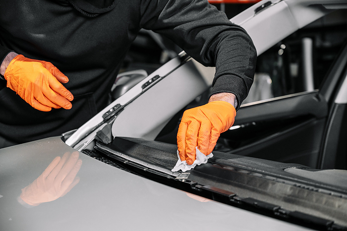 Close up, Car glazing, fixing and repairing a windshield. Windscreen replace process of a car at a garage service. Cleaning a dashboard. Close Up, Car Glazing, Fixing and Repairing A Windshield. Windscreen Replace Process of a Car at a Garage Service. Cleaning A Dashboard., by Zoonar DAVID HERRAEZ