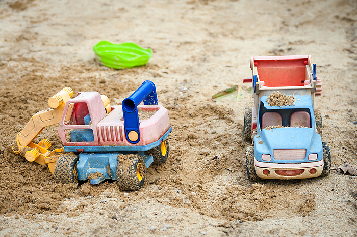 Bulldozer toy and truck at sandy playground Bulldozer Toy and Truck at Sandy Playground, by Zoonar Ewald Fr