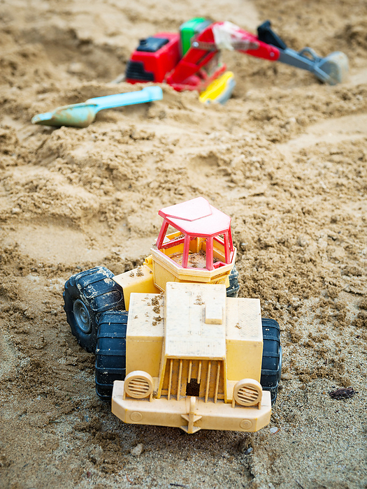 Bulldozer toy and truck at sandy playground Bulldozer Toy and Truck at Sandy Playground, by Zoonar Ewald Fr