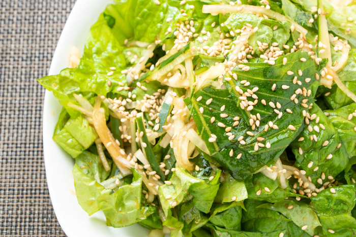 A close-up of the salad with sesame leaves and sanchu.
