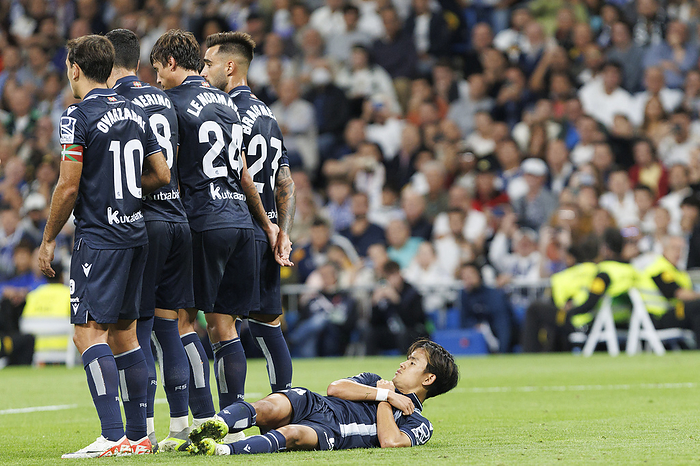 LA LIGA EA Sports   Real Madrid vs  Real Sociedad   MADRID, SPAIN   SEPTEMBER 17:Takefusa Kubo of Real Sociedad on the grass in a barrier during the LaLiga EA Sports 2023 24 match between Real Madrid and Real Sociedad at Santiago Bernabeu Stadium in Madrid on SEPTEMBER 17, 2023.  Photo by Guille Martinez 