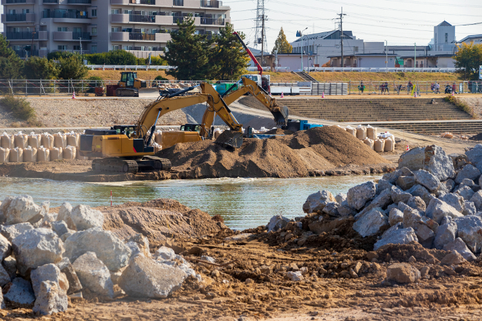 Hydraulic excavator digging soil at construction site