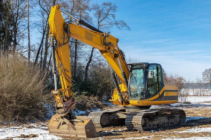Large excavator parked on a meadow in winter Large Excavator Parked on a Meadow in winter, by Zoonar ROBERT JANK