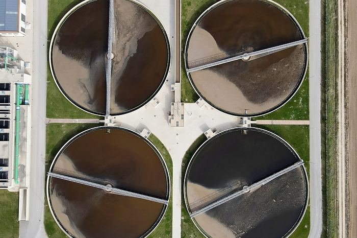 Aerial top view of round polls in wastewater treatment plant, filtration of dirty or sewage water. Aerial Top View of Round Polls in WASTEWATER TREATMENT Plant, Filtration of Dirty or Sewage Water., by Zoonar DAVID HERRAEZ