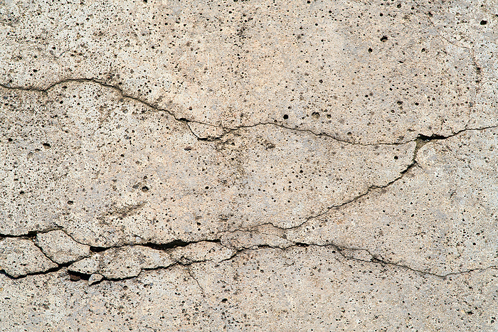Close up of cracks in a dilapidated concrete wall on a building Close Up of Cracks in A Dilapidated Concrete Wall on a Building, by Zoonar Heiko Kueverl