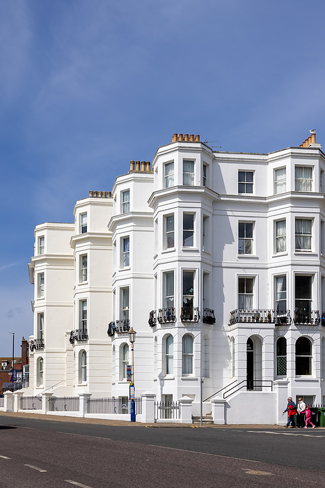 EASTBOURNE, EAST SUSSEX, UK   MAY 3 : View of some apartments in Eastbourne on May 3, 2021. Three unidentified people Eastbourne, East Sussex, UK   May 3: View of some Apartments in Eastbourne on May 3, 2021. Three Unidetified People, by Zoonar Phil Bird