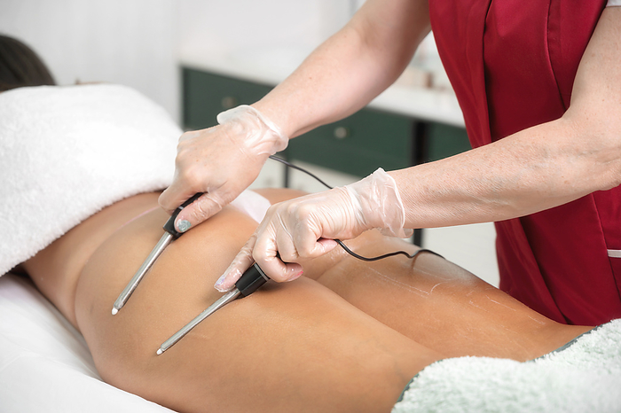 Woman having cosmetic galvanic beauty treatment in spa. Therapist applying low frequency current Woman Having Cosmetic Galvanic Beauty Treatment in Spa. Therapist Applying Low Frequency Current, by Zoonar DAVID HERRAEZ