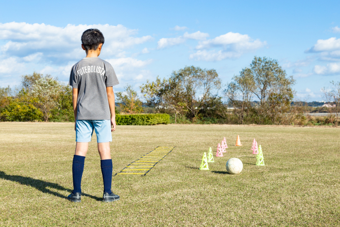 A boy practicing soccer