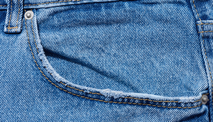 Blue jeans front pocket with buttons, close up Blue jeans front pocket with buttons, close up