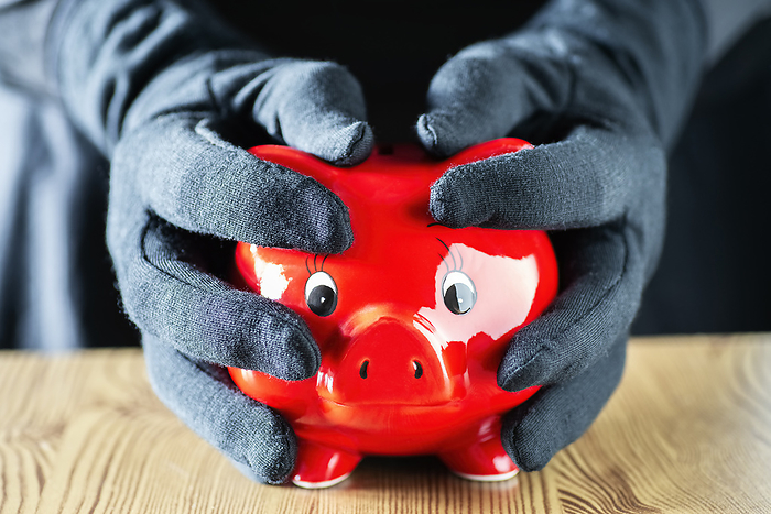 Hands in gloves embrace a piggy bank Hands in gloves embrace a piggy bank, by Zoonar gopixa