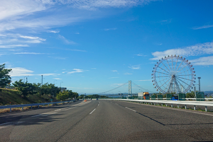 Akashi Kaikyo Bridge and Ferris wheel seen from the highway on Awaji Island