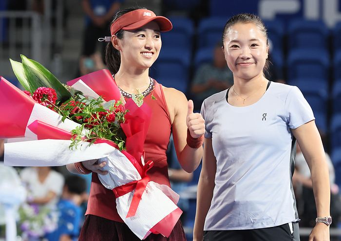 A second round match of the Toray Pan Pacific Open tennis tournament September 28, 2023, Tokyo, Japan   Misaki Doi of Japan  L  poses for photo with former tennis player Kurumi Nara  R  as she receives a flower bouquet from Nara after her game at the second round match of the Toray pan Pacific Open tennis tournament at the Ariake Colosseum  in Tokyo on Thursday, September 28, 2023. Doi was defeated by Maria Sakkari of Greece 3 6, 1 6 and withdrew from her professional carrier.    photo by Yoshio Tsunoda AFLO 
