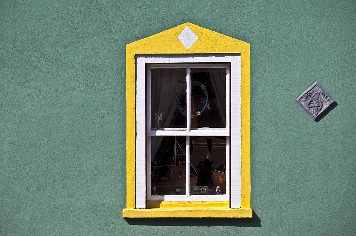 Ireland Aquamarine colour wall and yellow window border in Kinsale, County Cork, Ireland