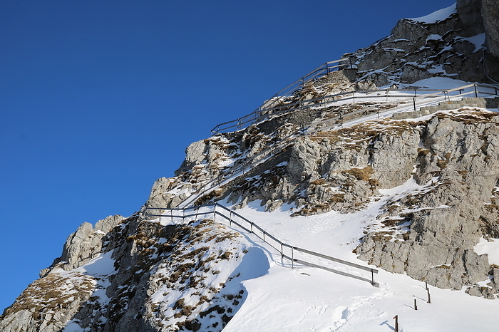 Snow covered stairs leading to the Esel, one of the peaks of Mount Pilatus. Snow covered stairs leading to the Esel, one of the peaks of Mount Pilatus., by Zoonar Ursula Perret