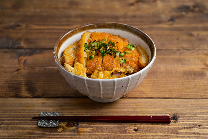 bowl of rice topped with chicken and katsuobushi