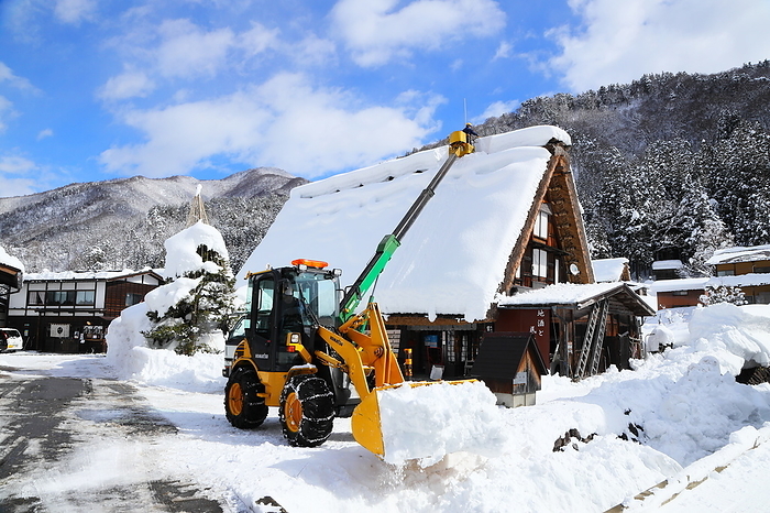 Snow removal from a gassho-style house, Shirakawa Village, Gifu Prefecture, Japan