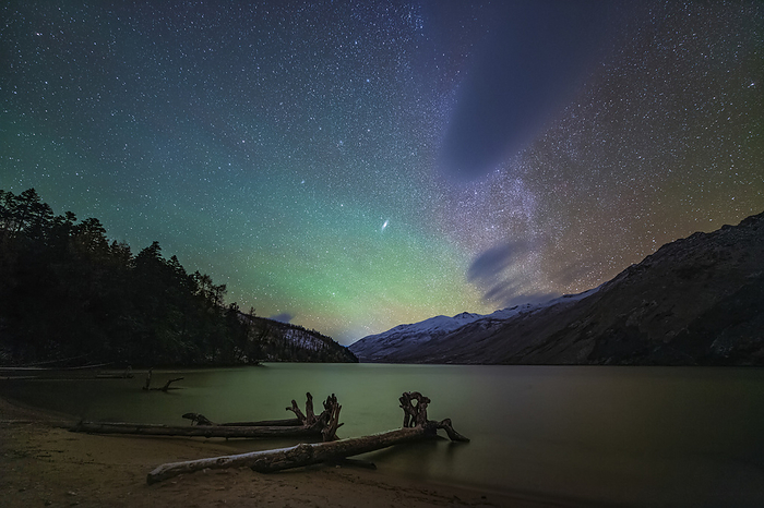 Airglow and Milky Way over Lake Mugecuo, China Green airglow and Milky Way over Lake Mugecuo in Kangding, Sichuan, China. Airglow occurs in Earth s atmosphere as sunlight interacts with the atoms and molecules within it. The Milky Way is our galaxy seen from the inside. It appears as a hazy band of stars and nebulae stretching across the sky. Photographed on 28 October 2019., by JEFF DAI   SCIENCE PHOTO LIBRARY