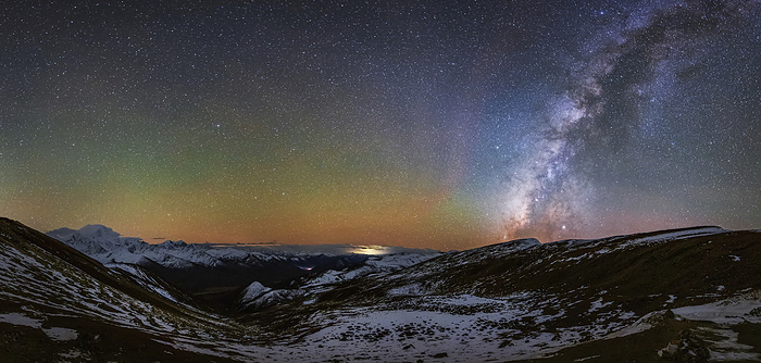 Airglow over Mount Gongga, Sichuan, China Green and yellow airglow  centre  and Milky Way  right  over Mount Gongga in Sichuan, China. Airglow occurs in Earth s atmosphere as sunlight interacts with the atoms and molecules within it. The Milky Way is our galaxy seen from the inside. It appears as a hazy band of stars and nebulae stretching across the sky. Photographed on 29 October 2019., by JEFF DAI   SCIENCE PHOTO LIBRARY