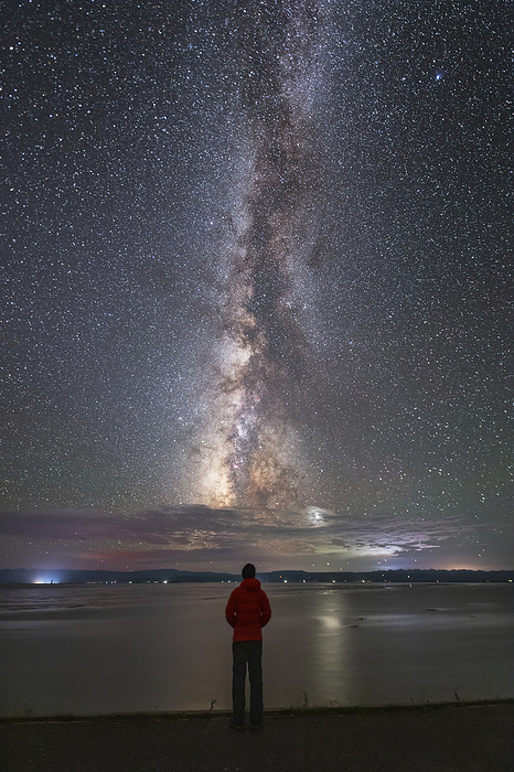 Stargazer under Milky Way, Qinghai lake, China Stargazer standing under the Milky Way at Qinghai Lake in China. The Milky Way is our galaxy seen from the inside. It appears as a hazy band of stars and nebulae stretching across the sky. Photographed on 29 August 2019., by JEFF DAI   SCIENCE PHOTO LIBRARY