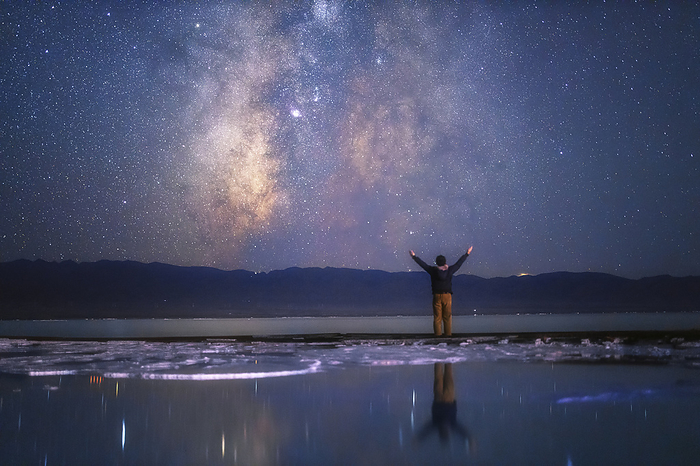 Stargazer looking towards sky, Qinghai, China Stargazer looking towards the southern sky at the Chaka salt lake in Qinghai, China. The band of the Milky Way way can be seen at centre. The Milky Way is our galaxy seen from the inside. It appears as a hazy band of stars and nebulae stretching across the sky. Photographed on 1 September 2019., by JEFF DAI   SCIENCE PHOTO LIBRARY
