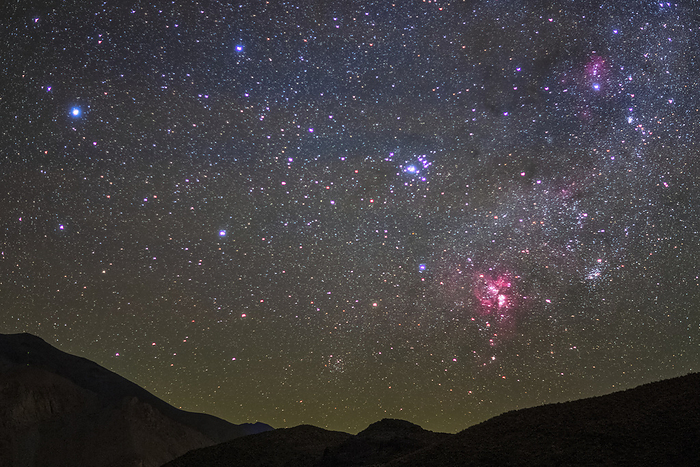 Southern sky above Atacama desert, Chile The red cloud at lower right is the Carina Nebula, a large star forming region in the Carina. To its upper left is the Wishing Well Cluster, a bright open star cluster in the constellation Carina. Photographed on 1 July 2019. by JEFF DAI   SCIENCE PHOTO LIBRARY