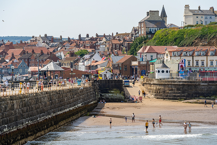 WHITBY,  NORTH YORKSHIRE, UK   JULY 19: View of the sea front in Whitby, North Yorkshire on July 19, 2022. Unidentified people WHITBY,  NORTH YORKSHIRE, UK   JULY 19: View of the sea front in Whitby, North Yorkshire on July 19, 2022. Unidentified people, by Zoonar Phil Bird