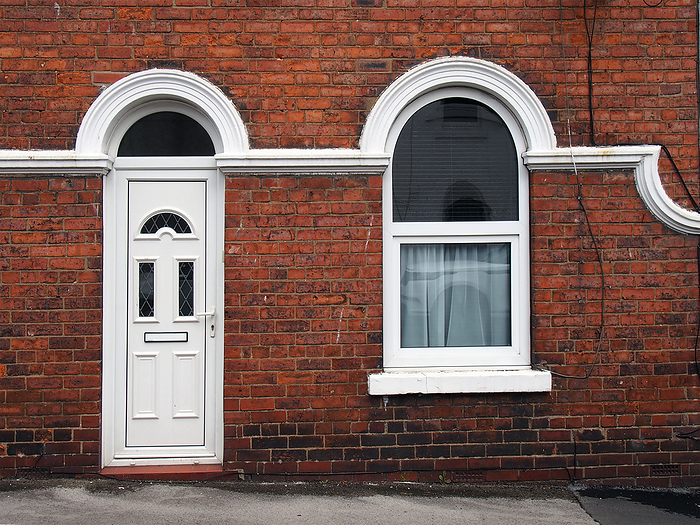 white front door and window of a typical old brick british terraced house with white decorative paintwork white front door and window of a typical old brick british terraced house with white decorative paintwork, by Zoonar PHILIP_OPENSH