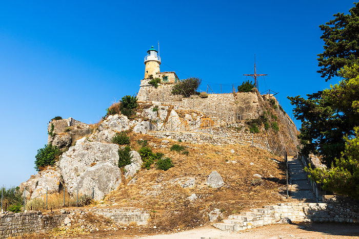 Lighthouse and cross on top of the old fortress, Kerkyra, Corfu Lighthouse and cross on top of the old fortress, Kerkyra, Corfu, by Zoonar ROBERT JANK