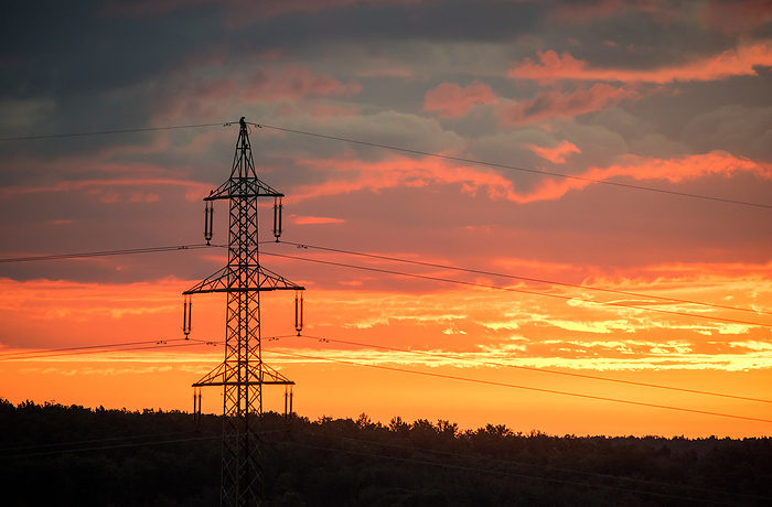 voltage electric pylon and electrical wire with sunset sky. Electricity poles. Power and energy concept. voltage electric pylon and electrical wire with sunset sky. Electricity poles. Power and energy concept., by Zoonar Ewald Fr