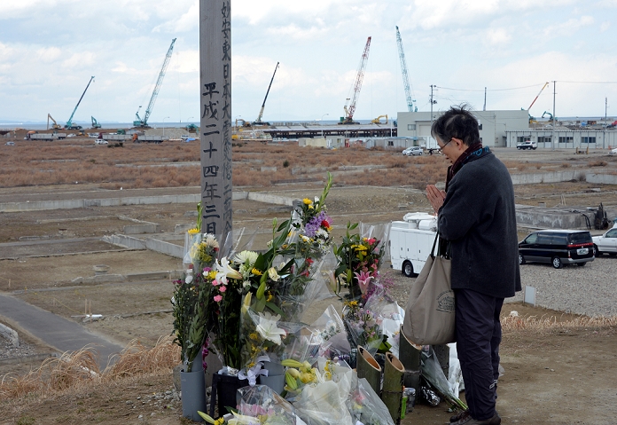 Three years have passed since the Great East Japan Earthquake Silent prayer at the time of the earthquake March 11, 2014, Yuriage machi, Japan   A local family pays homage to the tsunami victims on Tuesday, March 11, 2014, as they visit the family grave in Yuriage machi, Miyagi prefecture, that was swept away on that tragic day three years ago. Japan marked the third anniversary of the quake tsunami diaster which swallowed up the lives of 18,000 people, destroyed cities, towns and fishing villages along the country s northeastern Pacific coast.   Photo by Natsuki Sakai AFLO  AYF  mis 