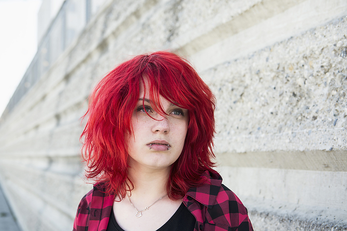 Young rebellious sad teenage girl piercings, by Cavan Images / Edith Drentwett
