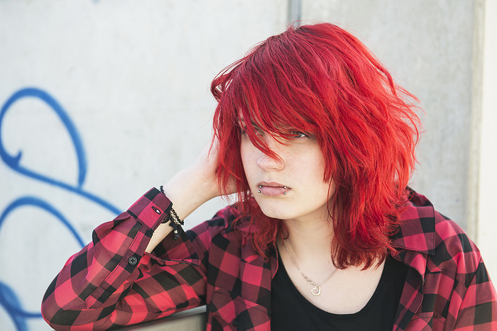 Portrait young teenage girl piercings dyed hair, by Cavan Images / Edith Drentwett