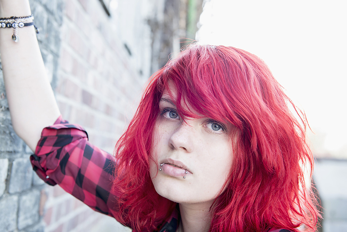 Close up Punk teenage girl piercings dyed hair, by Cavan Images / Edith Drentwett