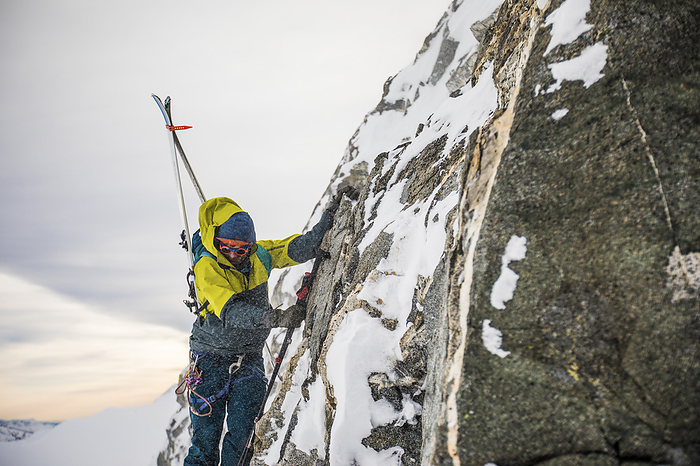 Skier carefully navigates a cliff face on approach to the summit, by Cavan Images / Christopher Kimmel / Alpine Edge Photography