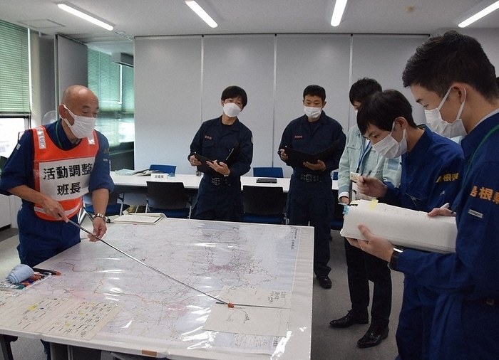 Shimane Prefecture officials confirm evacuation routes in front of a map of the Shimane Nuclear Power Plant area during a drill. Shimane Prefecture officials confirm evacuation routes in front of a map of the area around the Shimane Nuclear Power Plant during a drill at the prefectural office in Tonomachi, Matsue City at 9:12 a.m. on October 19, 2023.