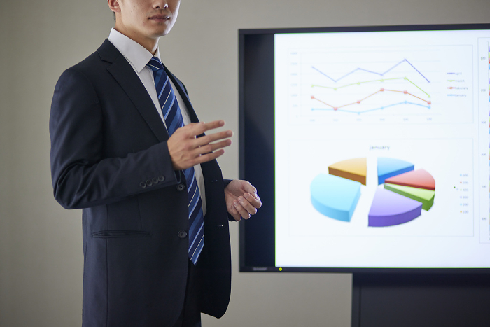 Young Japanese male businessman giving a presentation in a conference room (People)