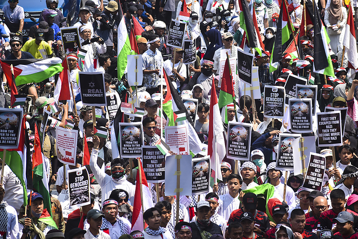 Thousands of people at Pro Palestinian Demonstration in West Java Indonesia People hold placards and raise a Palestinian flags as they gather for a pro Palestinian demonstration in Bandung, West Java,Indonesia on October 21, 2023. Thousands of people attend the demonstration to condemn against genocide of the government of Israel and express solidarity with the Palestinian people.