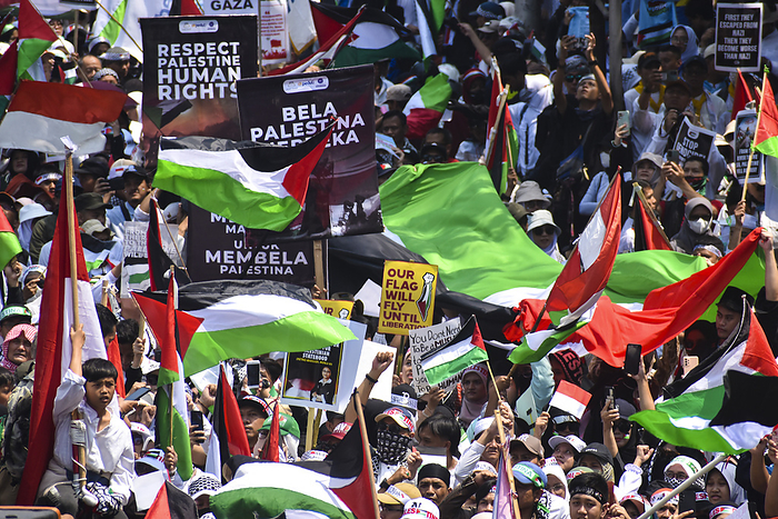 Thousands of people at Pro Palestinian Demonstration in West Java Indonesia People hold placards and raise a Palestinian flags as they gather for a pro Palestinian demonstration in Bandung, West Java,Indonesia on October 21, 2023. Thousands of people attend the demonstration to condemn against genocide of the government of Israel and express solidarity with the Palestinian people.