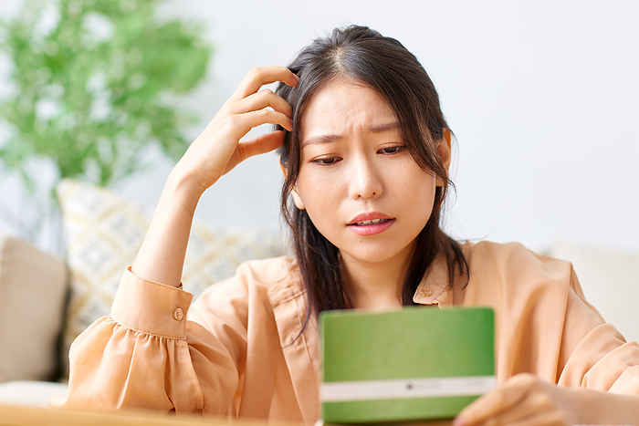 Japanese woman disappointed when she sees a bank book