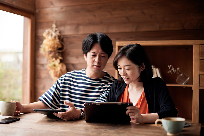 Japanese couple looking at tablets