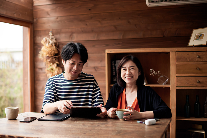Japanese couple looking at tablets