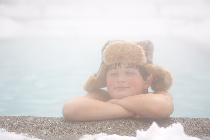 Little Boy Relaxing in Outdoor Pool at Ski Resort, by Albert C. Karges / Design Pics