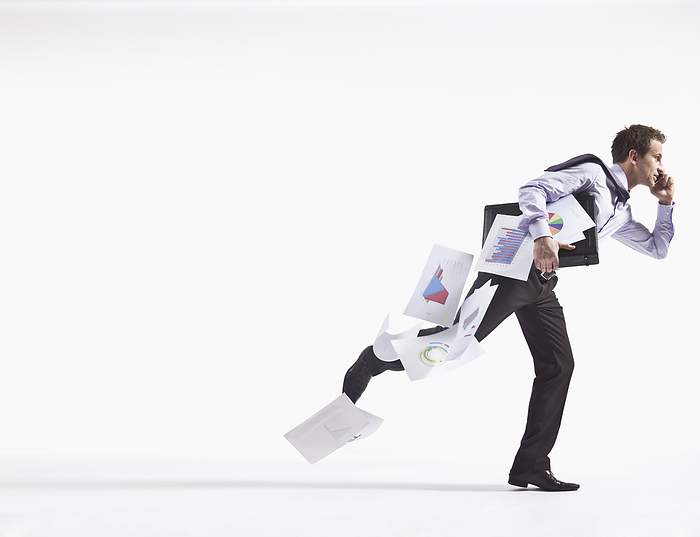 Hurried Businessman Dropping Papers, by Bernhard Haselbeck / Design Pics