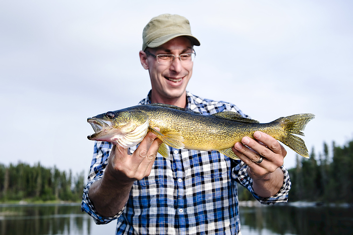 Man Fishing, Otter Lake, Missinipe, Saskatchewan, Canada, by Christopher Hendrickson / Design Pics