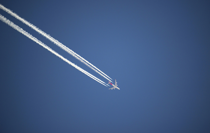 Canada Airplane and contrails against blue sky, Canada, by Douglas E. Walker   Design Pics