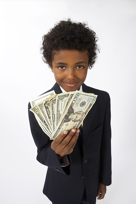 Little Boy Dressed Up as a Businessman Holding Cash, by Edward Pond / Design Pics