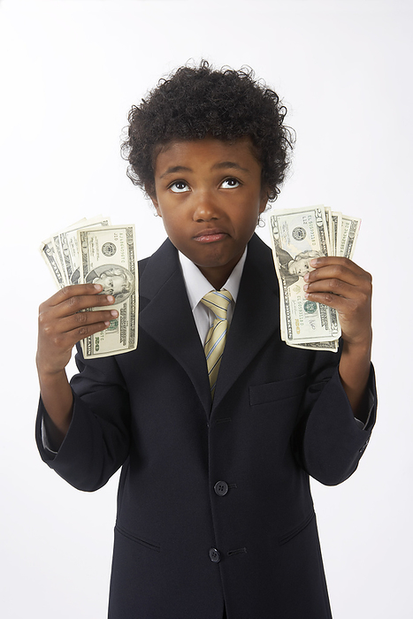 Little Boy Dressed Up as a Businessman Holding Cash, by Edward Pond / Design Pics