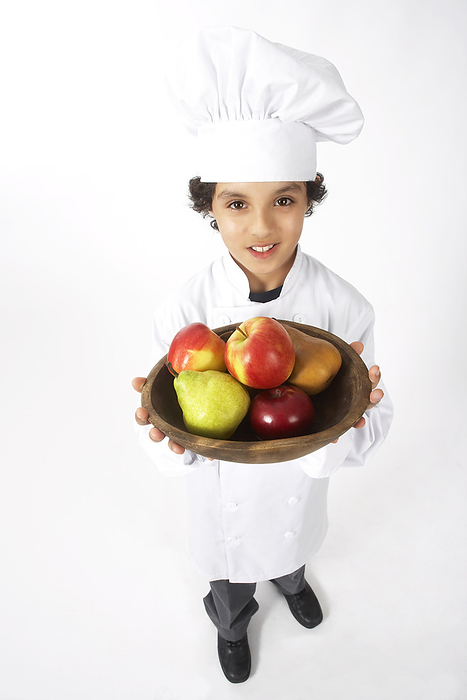 Boy Dressed Up as a Chef Holding Bowl of Fruit, by Edward Pond / Design Pics