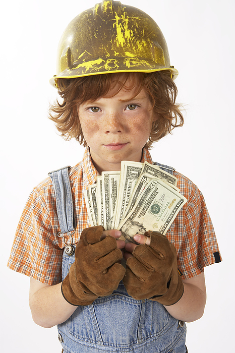 Little Boy Dressed Up as Construction Worker Holding Cash, by Edward Pond / Design Pics